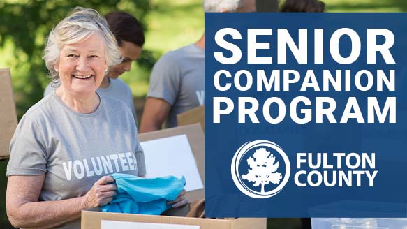 smiling senior with a shirt that says volunteer